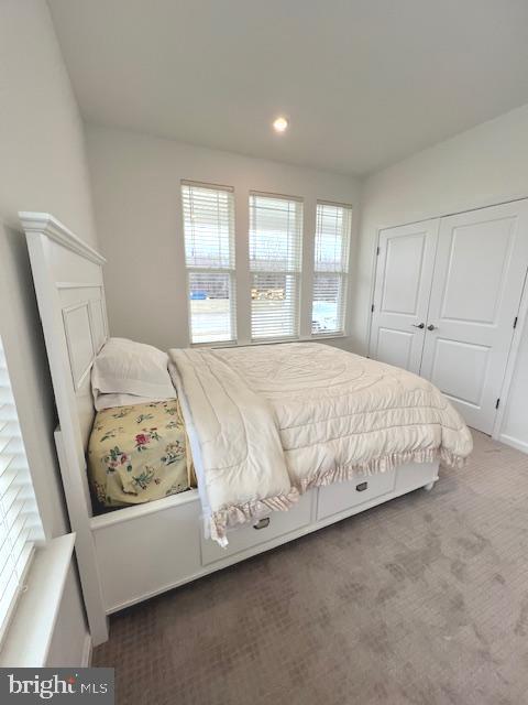 bedroom featuring a closet and carpet flooring