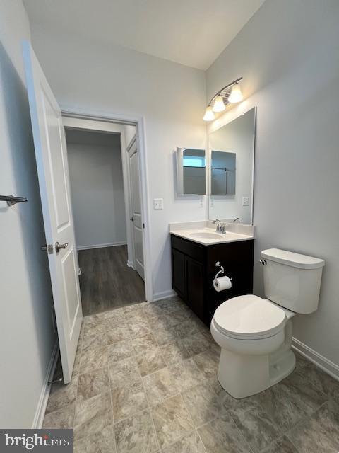 bathroom featuring toilet and vanity