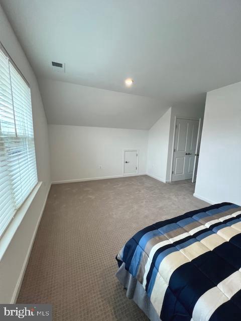 carpeted bedroom featuring vaulted ceiling