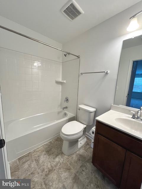 full bathroom featuring toilet, vanity, and bathing tub / shower combination