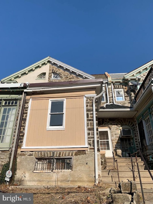 view of side of property with stone siding