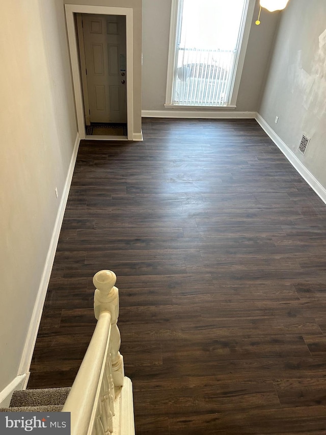 unfurnished room featuring dark hardwood / wood-style floors