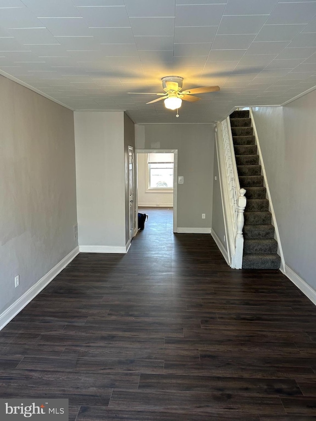 unfurnished living room featuring ceiling fan and dark hardwood / wood-style flooring