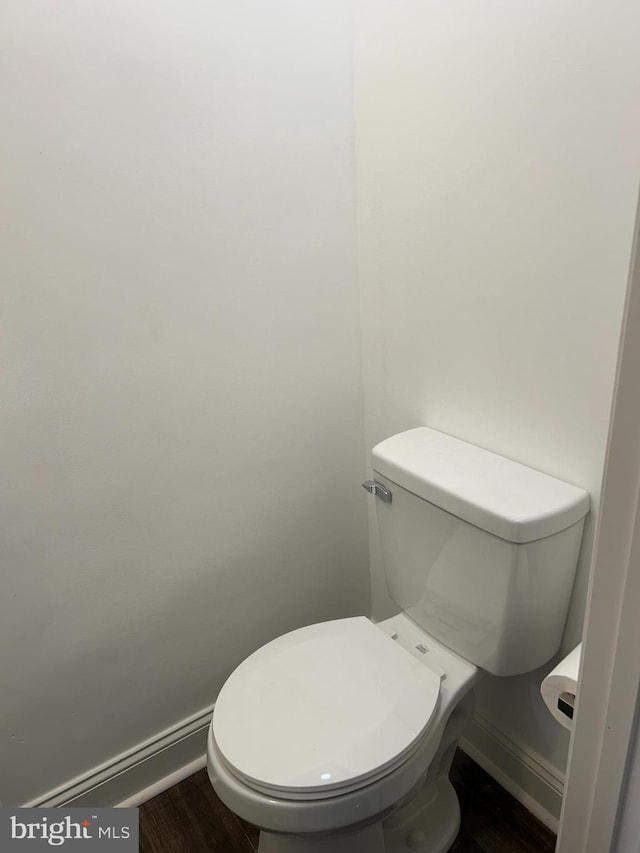 bathroom featuring toilet and wood-type flooring