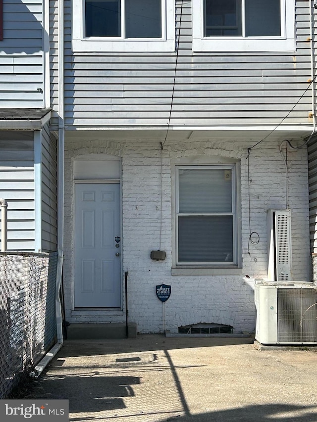 doorway to property featuring central air condition unit