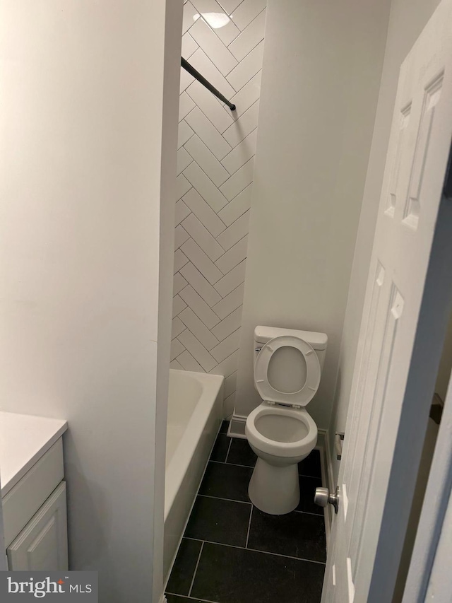 bathroom featuring toilet, tile patterned flooring, and vanity