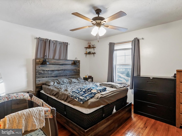 bedroom with wood-type flooring and ceiling fan