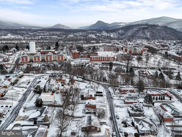 snowy aerial view featuring a mountain view