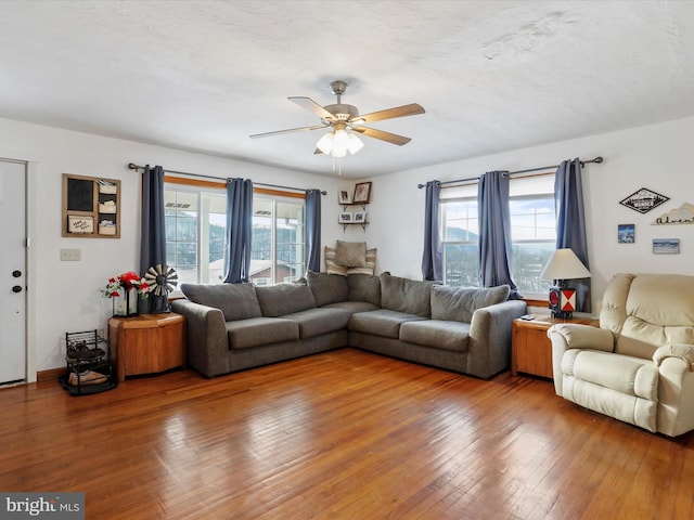 living room featuring ceiling fan and hardwood / wood-style floors