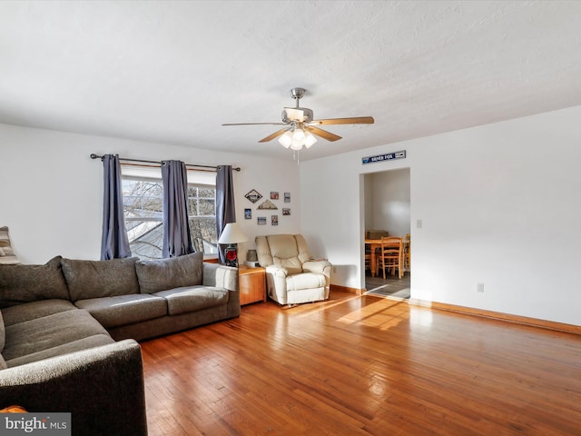 living room featuring hardwood / wood-style flooring and ceiling fan