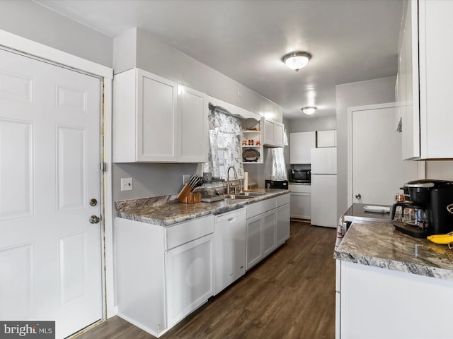 kitchen featuring white fridge, dishwasher, dark wood-type flooring, sink, and white cabinetry