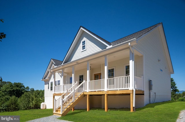 view of front of home with covered porch and a front lawn