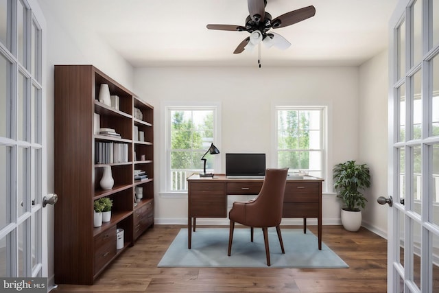 office area featuring ceiling fan, french doors, a healthy amount of sunlight, and dark hardwood / wood-style floors