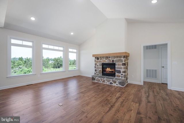 unfurnished living room with high vaulted ceiling, dark wood-type flooring, and a stone fireplace