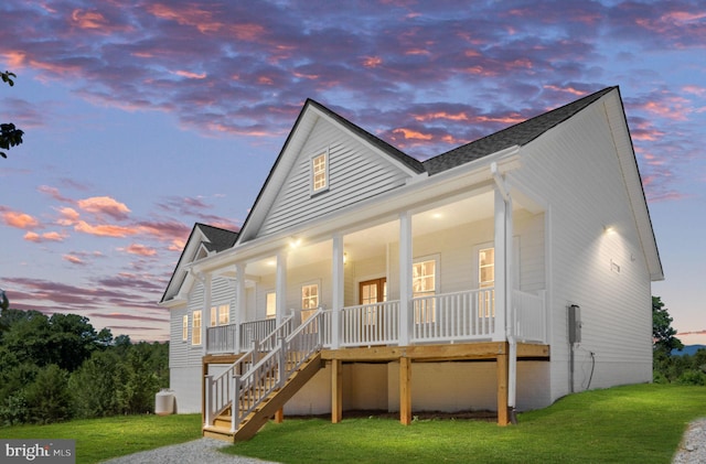 exterior space featuring a porch and a lawn