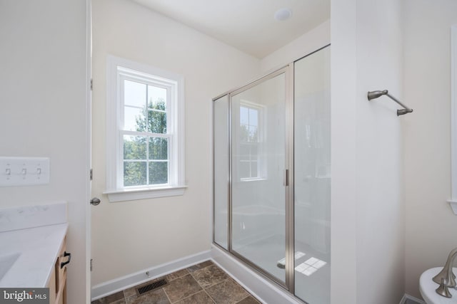 bathroom featuring walk in shower and vanity