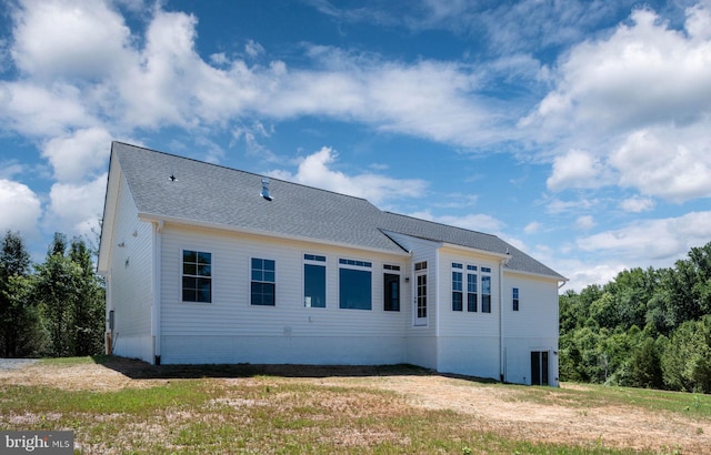 rear view of property with a lawn