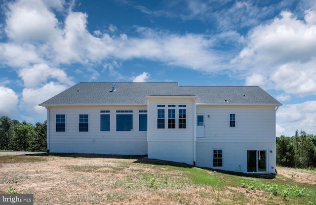 rear view of house with a yard