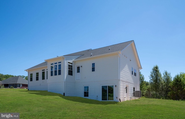 back of house featuring a yard and central AC unit