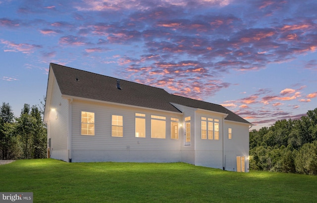 back house at dusk with a yard