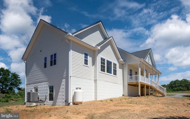 view of home's exterior featuring a porch and cooling unit