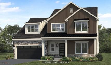 view of front of house with a front yard and a garage