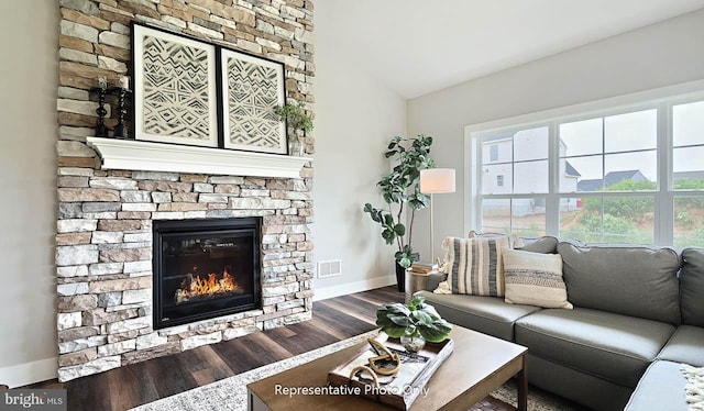 living room with a fireplace and wood-type flooring