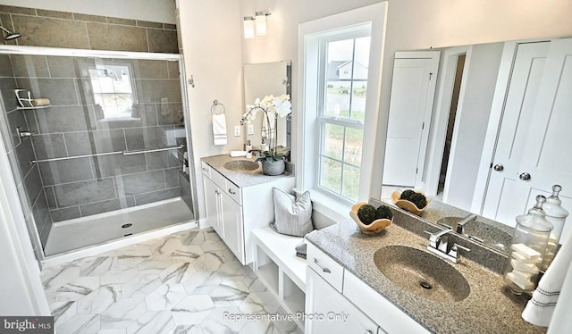 bathroom featuring tiled shower and vanity