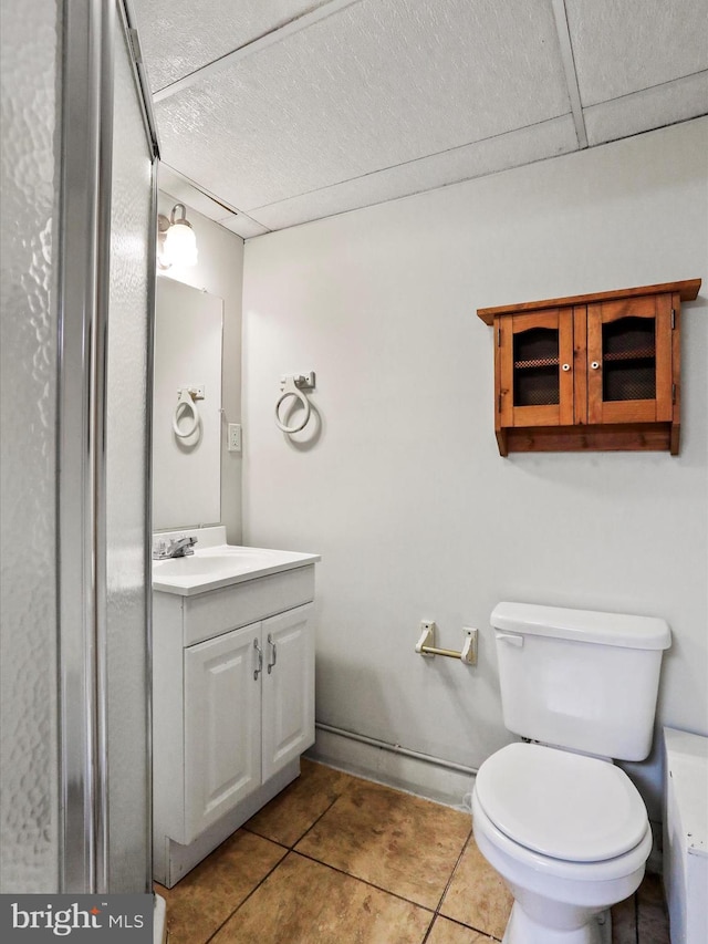 bathroom featuring vanity, tile patterned floors, and toilet