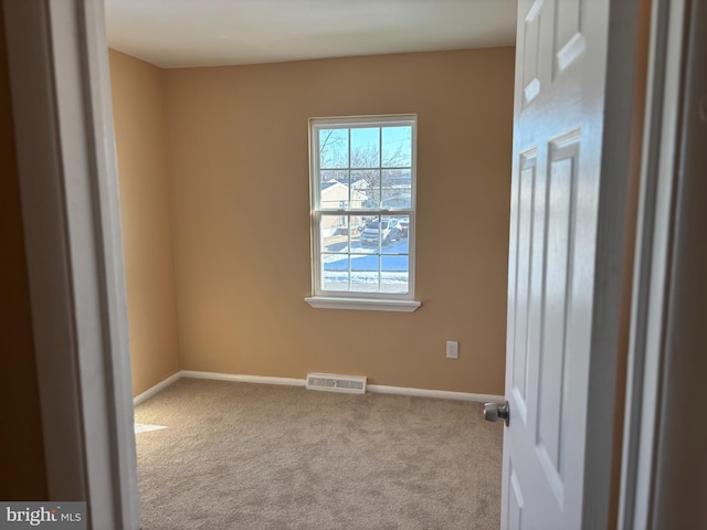 spare room with light carpet