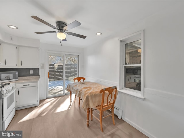 dining room featuring ceiling fan and light hardwood / wood-style flooring