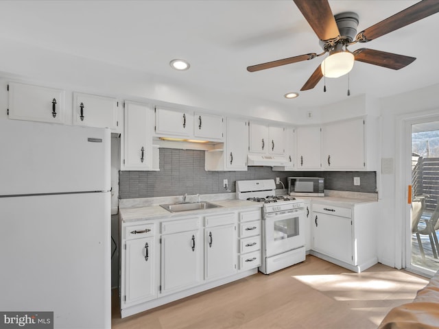 kitchen featuring white appliances, light wood-type flooring, white cabinetry, and sink