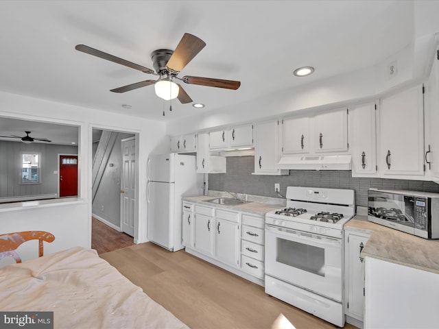 kitchen featuring sink, white appliances, white cabinetry, and light hardwood / wood-style floors