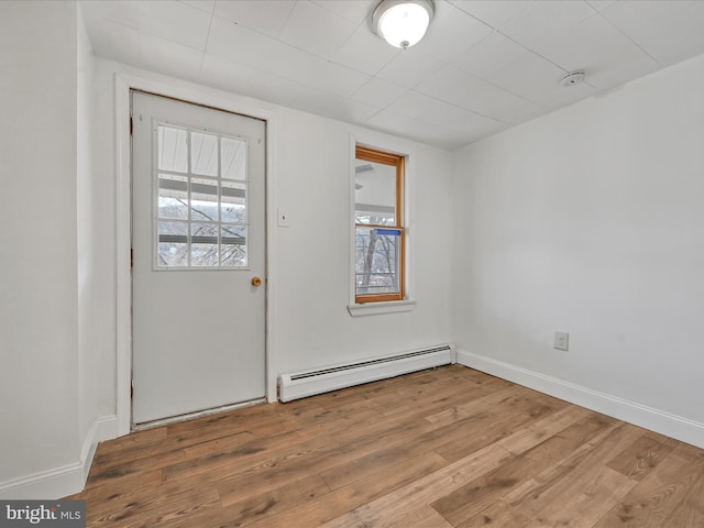 entryway featuring hardwood / wood-style flooring, a baseboard radiator, and plenty of natural light