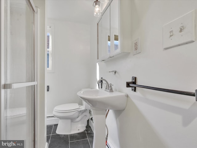 bathroom featuring a baseboard heating unit, tile patterned flooring, an enclosed shower, and toilet