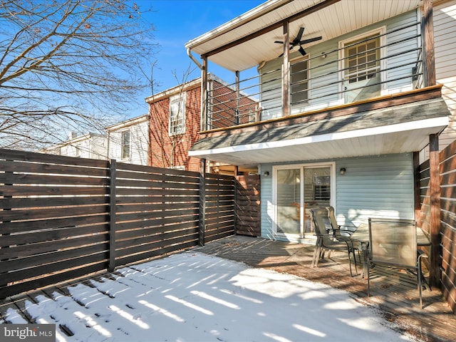 snow covered patio featuring ceiling fan