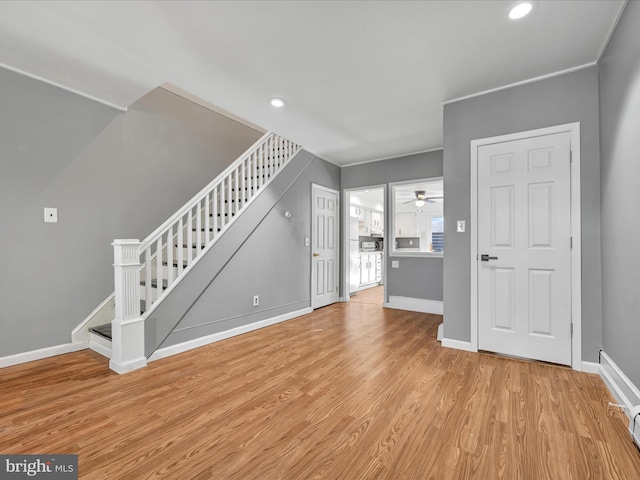 unfurnished living room featuring light hardwood / wood-style floors and ceiling fan