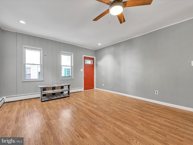 unfurnished living room featuring ceiling fan and light hardwood / wood-style flooring