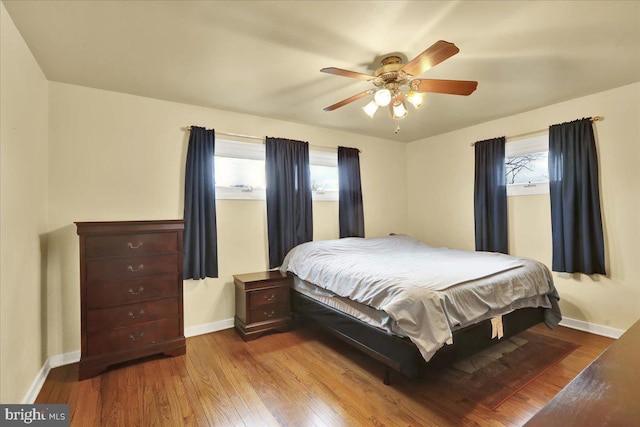 bedroom with ceiling fan and light wood-type flooring