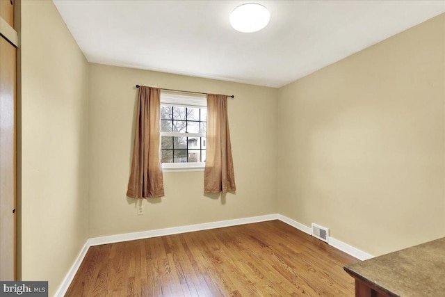 spare room with wood-type flooring