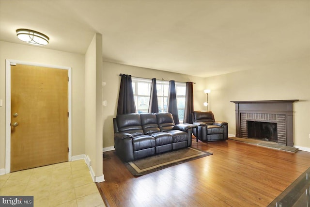 living room featuring a fireplace and light wood-type flooring