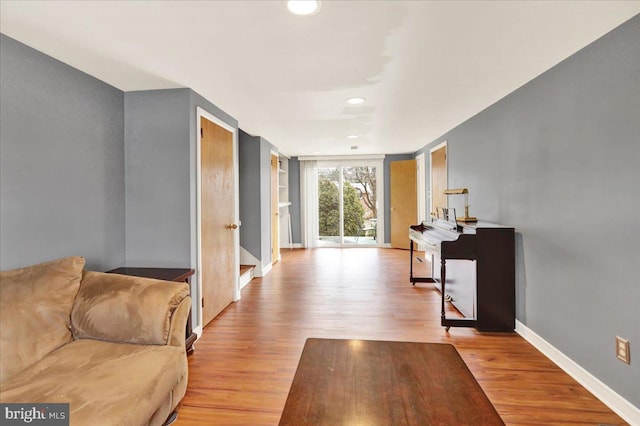 hallway with light hardwood / wood-style floors and built in features