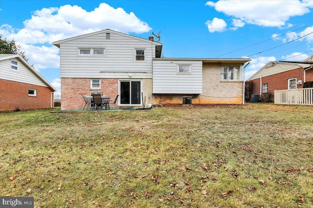 back of house with a patio area and a yard