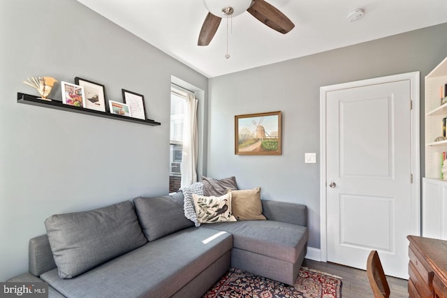 living room featuring ceiling fan and hardwood / wood-style floors