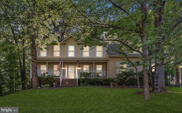 view of front facade with covered porch and a front yard