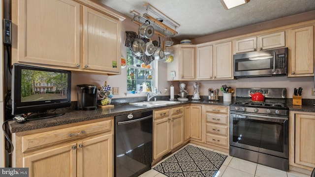 kitchen with stainless steel appliances, sink, and light brown cabinets