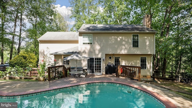 back of property with a swimming pool side deck