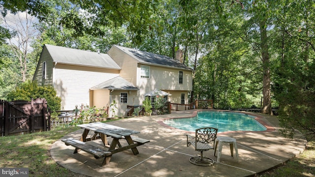 view of swimming pool featuring a deck and a patio area