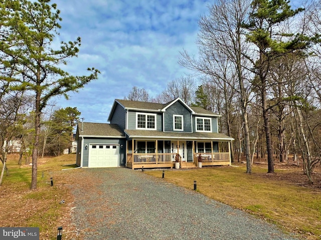 farmhouse inspired home with a front yard, a garage, and a porch