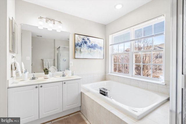 bathroom featuring vanity and plus walk in shower